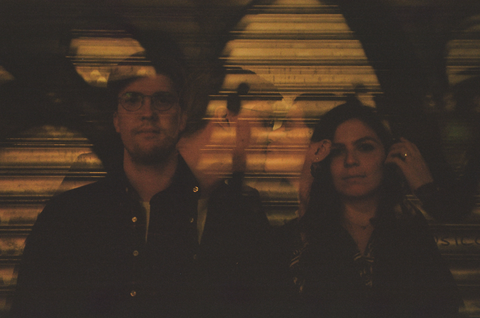 Double exposure of hunsband and wife facing the camera then giving
        each other a kiss