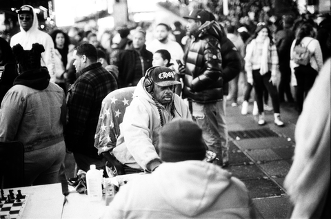 Man playing chess in Times Square amid nightly chaos