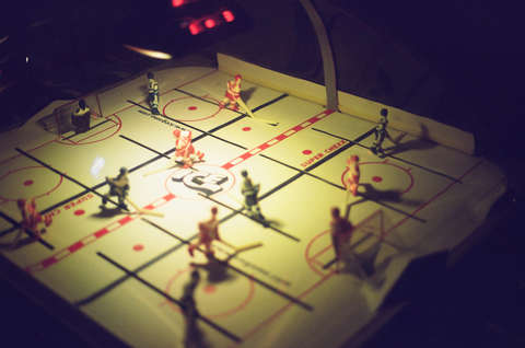 Dimly lit table top hockey game in a bar